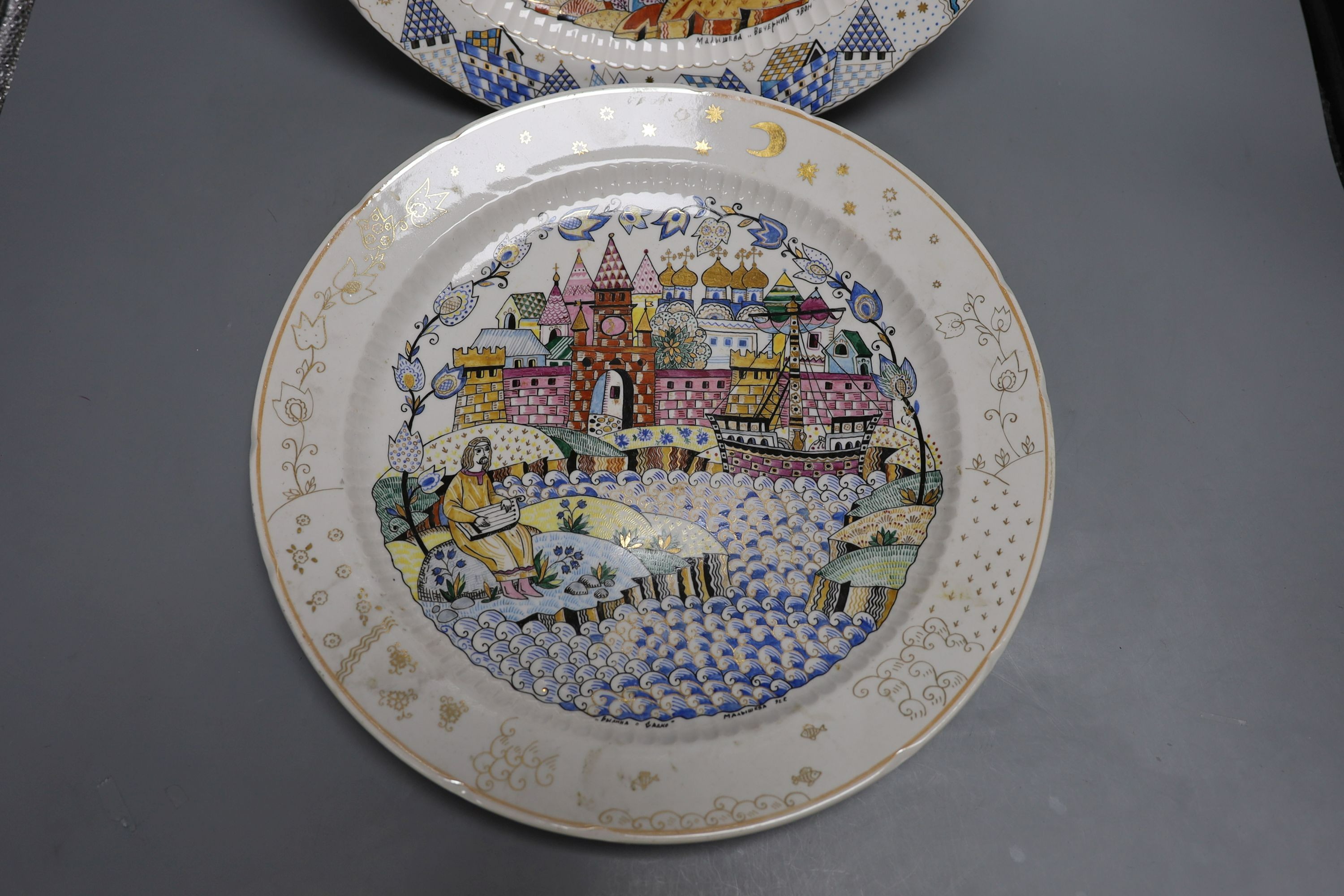 A pair of Russian porcelain dishes, painted by Malysheva and dated 1992, 35cm diameter